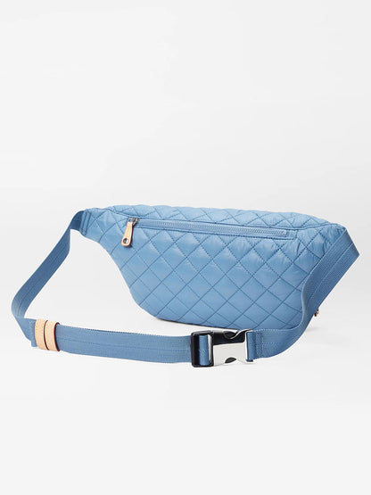 Cornflower Blue Oxford quilted sustainable REC Nylon fanny pack with an adjustable waist strap against a white background.