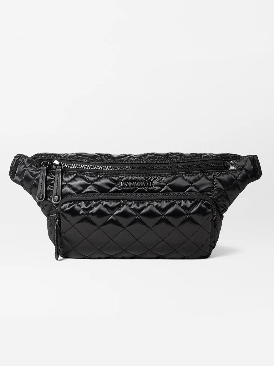 The MZ Wallace Metro Sling in Black Liquid Oxford is a quilted fanny pack with multiple zippered compartments and an adjustable strap, providing a stylish and convenient hands-free bag option.