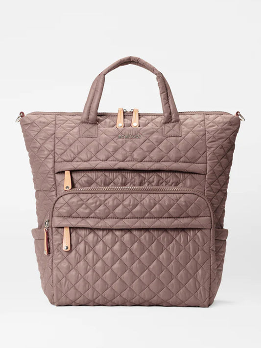 MZ Wallace Metro Utility Backpack in Mauve Oxford with multiple zippered compartments and gold-tone hardware on a plain white background.