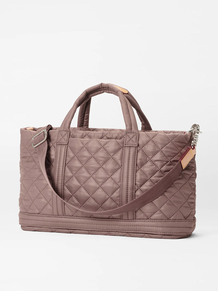 Quilted MZ Wallace Metro Utility Crossbody in Mauve Oxford bag with padded nylon handles, a detachable crossbody strap, and external zipper charm on a white background.