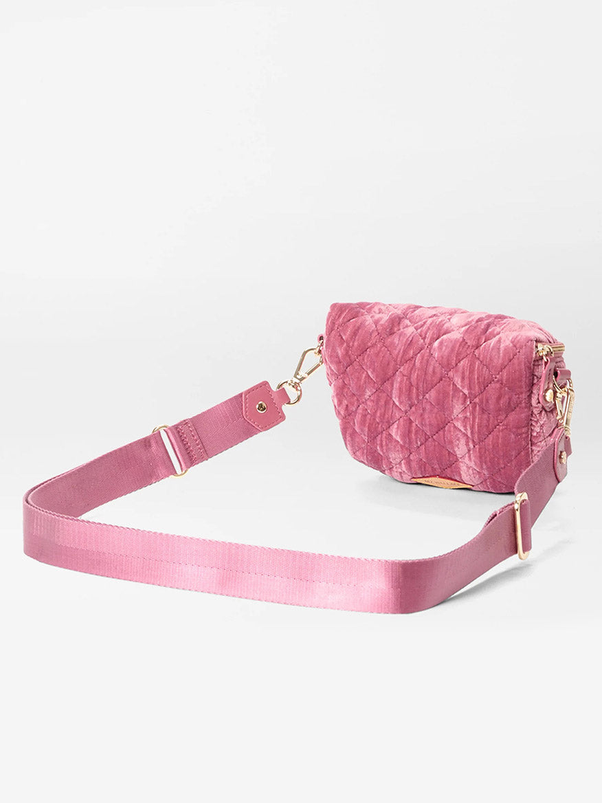 The MZ Wallace Micro Crosby Crossbody Sling in Petal Velvet features pink quilted nylon, a matching adjustable strap, gold hardware, and zip closure—stylish and compact for any occasion, shown on a plain white background.