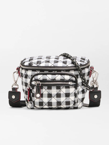 The MZ Wallace Micro Crosby Crossbody Sling in Black/White Gingham Oxford is a small recycled nylon bag featuring a checkered pattern, front zipper pockets, silver hardware, and a chain strap for hands-free convenience.