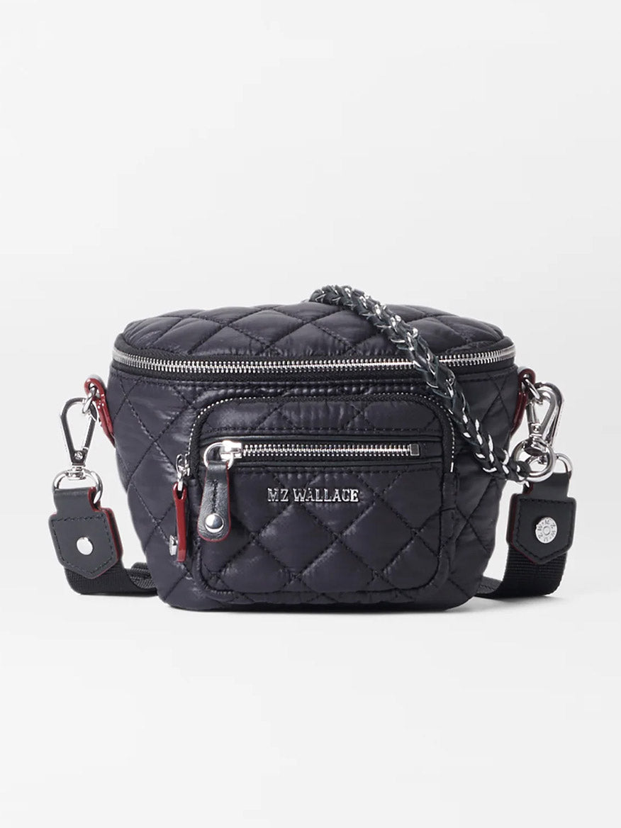 The MZ Wallace Micro Crosby Crossbody Sling in Black Oxford features a black quilted design, silver zippers, an adjustable strap, Italian leather trim, and "MZ WALLACE" branding on the front pocket.