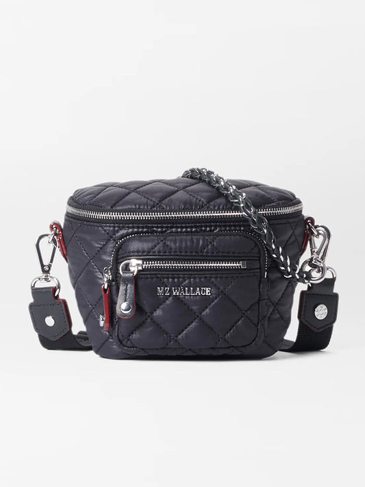 The MZ Wallace Micro Crosby Crossbody Sling in Black Oxford features a black quilted design, silver zippers, an adjustable strap, Italian leather trim, and "MZ WALLACE" branding on the front pocket.