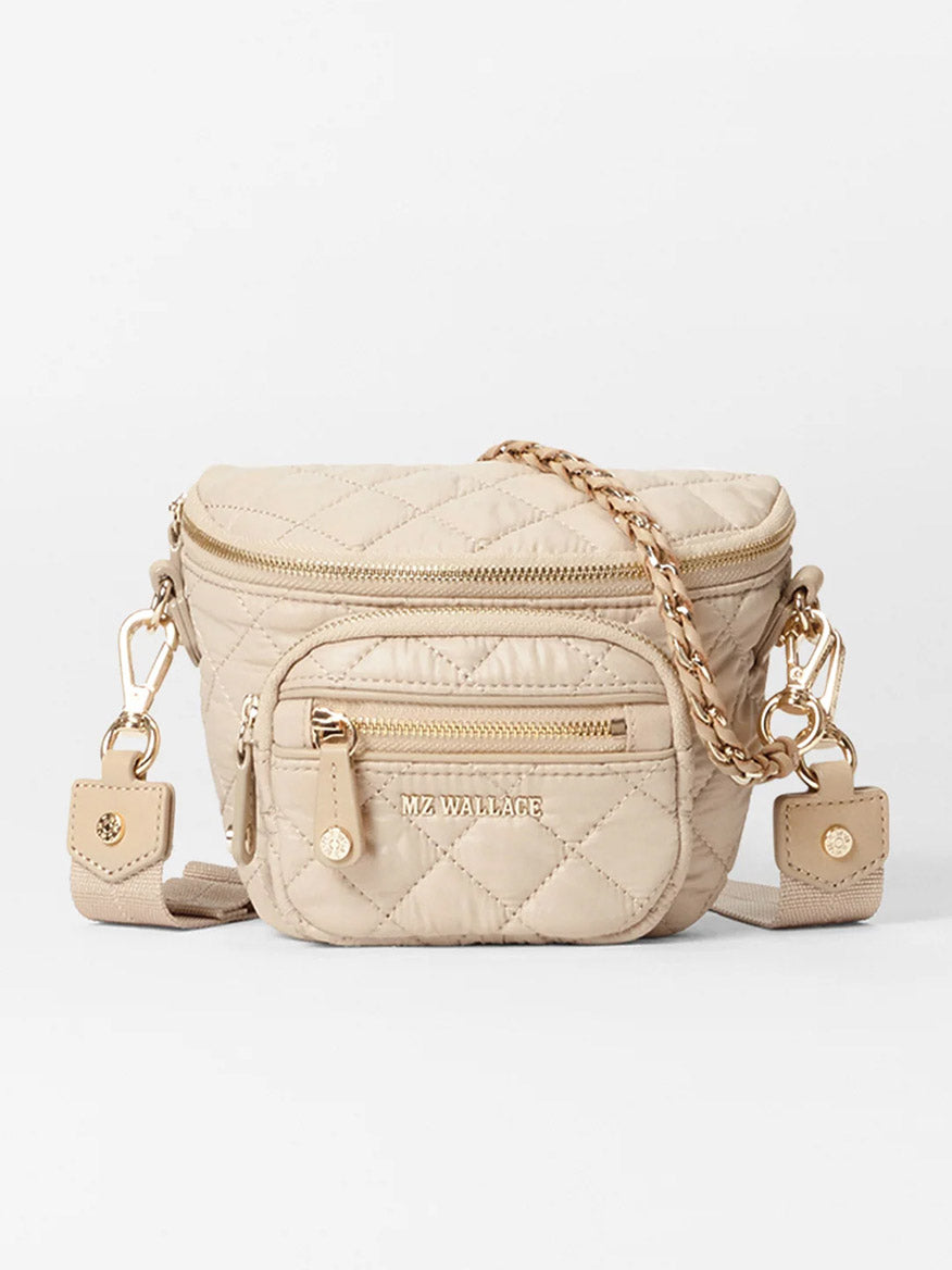 Buff Oxford micro quilted sling bag features gold hardware, a nylon crossbody strap, multiple zippered pockets, and MZ Wallace branding.