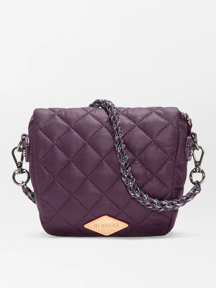 A compact, quilted MZ Wallace Micro Crosby Crossbody Sling in Raisin Oxford, featuring a chain strap and diamond-shaped logo patch on the front, crafted from recycled nylon for hands-free convenience.