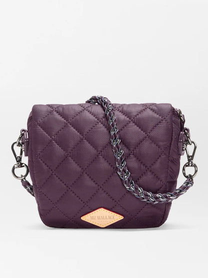 A compact, quilted MZ Wallace Micro Crosby Crossbody Sling in Raisin Oxford, featuring a chain strap and diamond-shaped logo patch on the front, crafted from recycled nylon for hands-free convenience.