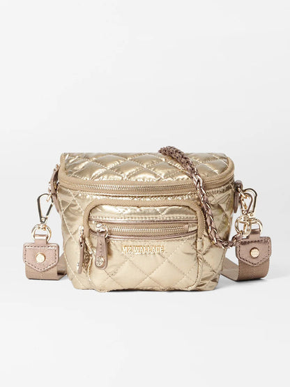 The MZ Wallace Micro Crosby Crossbody Sling in Antique Gold Metallic Oxford is a luxurious Italian leather bag featuring quilting, a front pocket, an elegant chain strap, and the "MZ Wallace" logo.