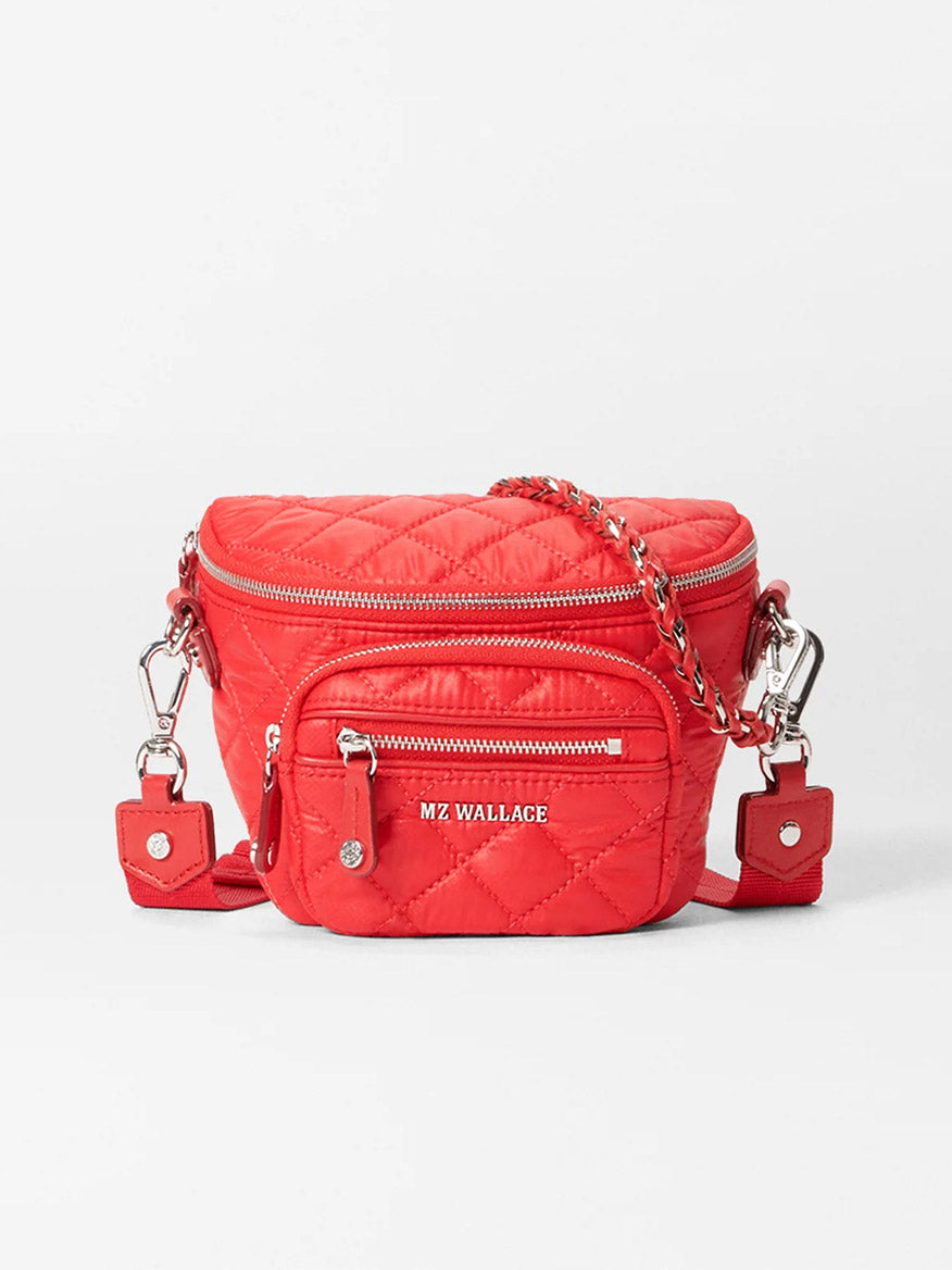 The MZ Wallace Micro Crosby Crossbody Sling in Bright Cherry Bedford is a red quilted mini nylon sling bag with multiple zippered compartments, a detachable crossbody strap, and features "MZ Wallace" branding.