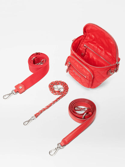 The MZ Wallace Micro Crosby Crossbody Sling in Bright Cherry Bedford includes a top zipper, front pocket, and three detachable straps: red web, braided, and solid red leather.