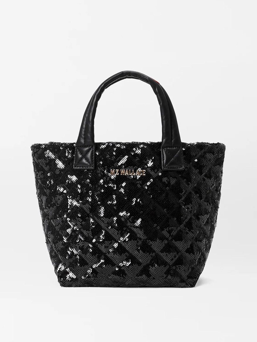 The MZ Wallace Micro Metro Tote Deluxe in Black Sequin is a quilted tote bag adorned with sequins and Italian leather trim, featuring two handles and a small logo on the front.