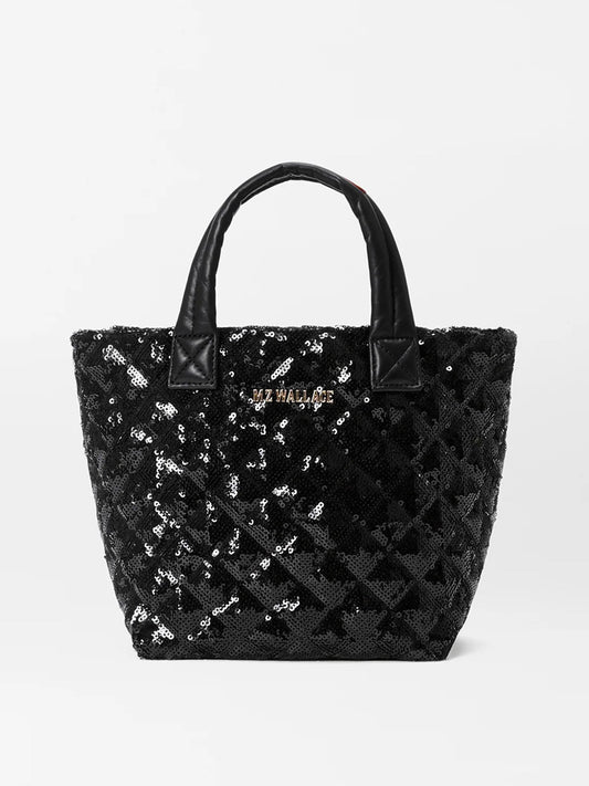 The MZ Wallace Micro Metro Tote Deluxe in Black Sequin is a quilted tote bag adorned with sequins and Italian leather trim, featuring two handles and a small logo on the front.