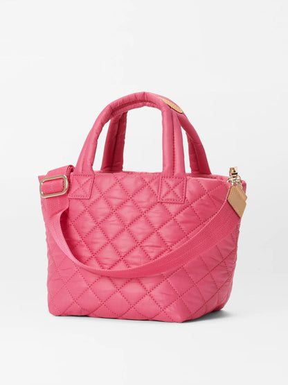A pink quilted MZ Wallace Micro Metro Tote Deluxe in Zinnia Oxford with gold-tone hardware and dual handles, displayed against a plain white background.