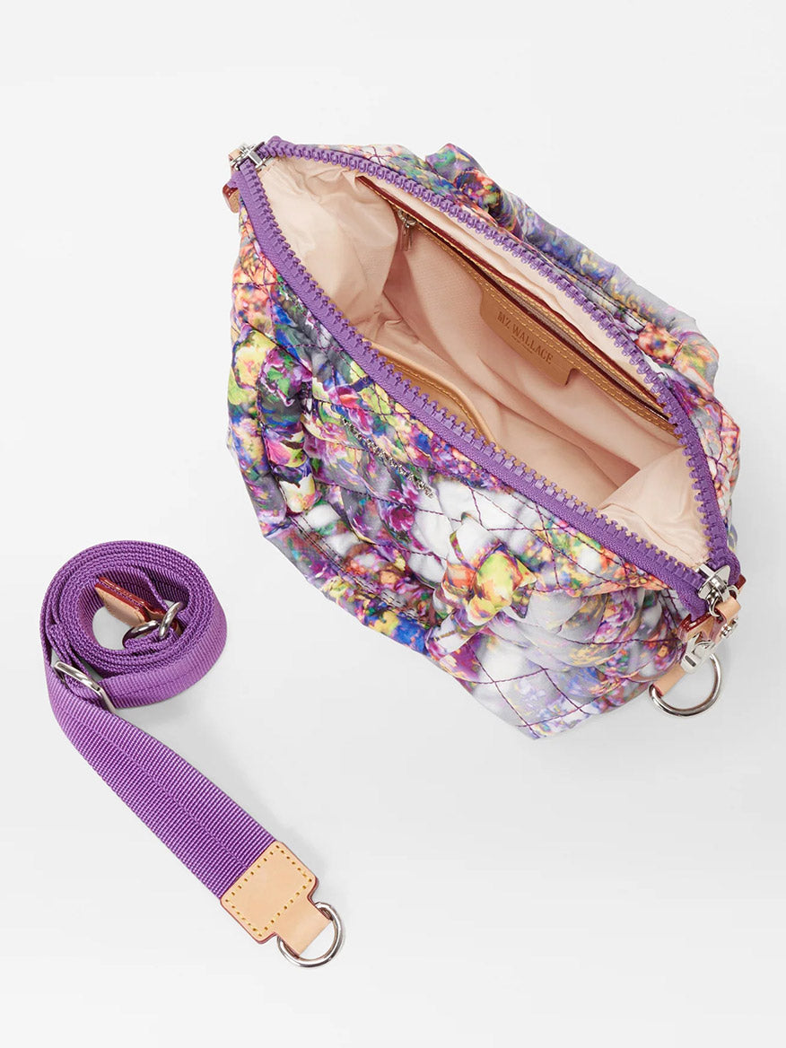 Open floral print MZ Wallace Micro Sutton in Cherry Blossom with a purple crossbody strap and zipper on a white background.