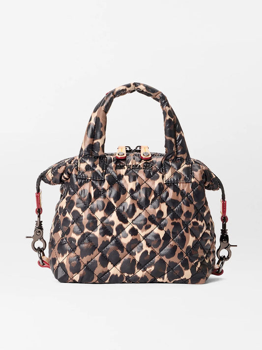 The MZ Wallace Micro Sutton in Leopard Oxford features a brown and black leopard print, short handles, and a detachable shoulder strap. Made from recycled oxford material, it can be used as a foldable crossbody for versatile wear.