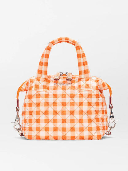 The MZ Wallace Micro Sutton in Sunset Orange Gingham Oxford is a quilted handbag made from recycled Oxford nylon, featuring top handles, silver hardware, zip closure, and an adjustable crossbody strap with detachable clips.