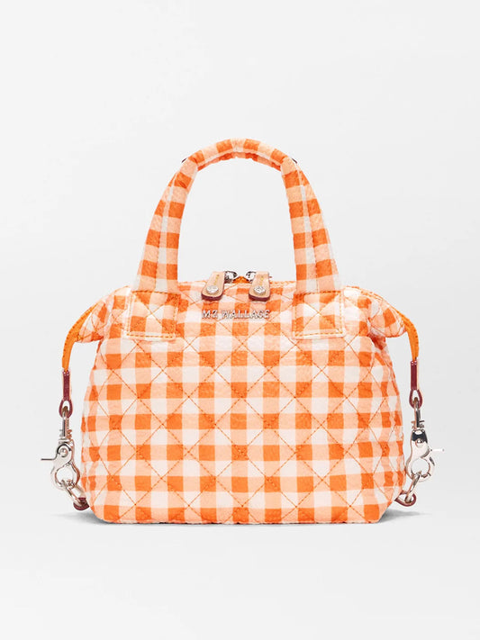 The MZ Wallace Micro Sutton in Sunset Orange Gingham Oxford is a quilted handbag made from recycled Oxford nylon, featuring top handles, silver hardware, zip closure, and an adjustable crossbody strap with detachable clips.