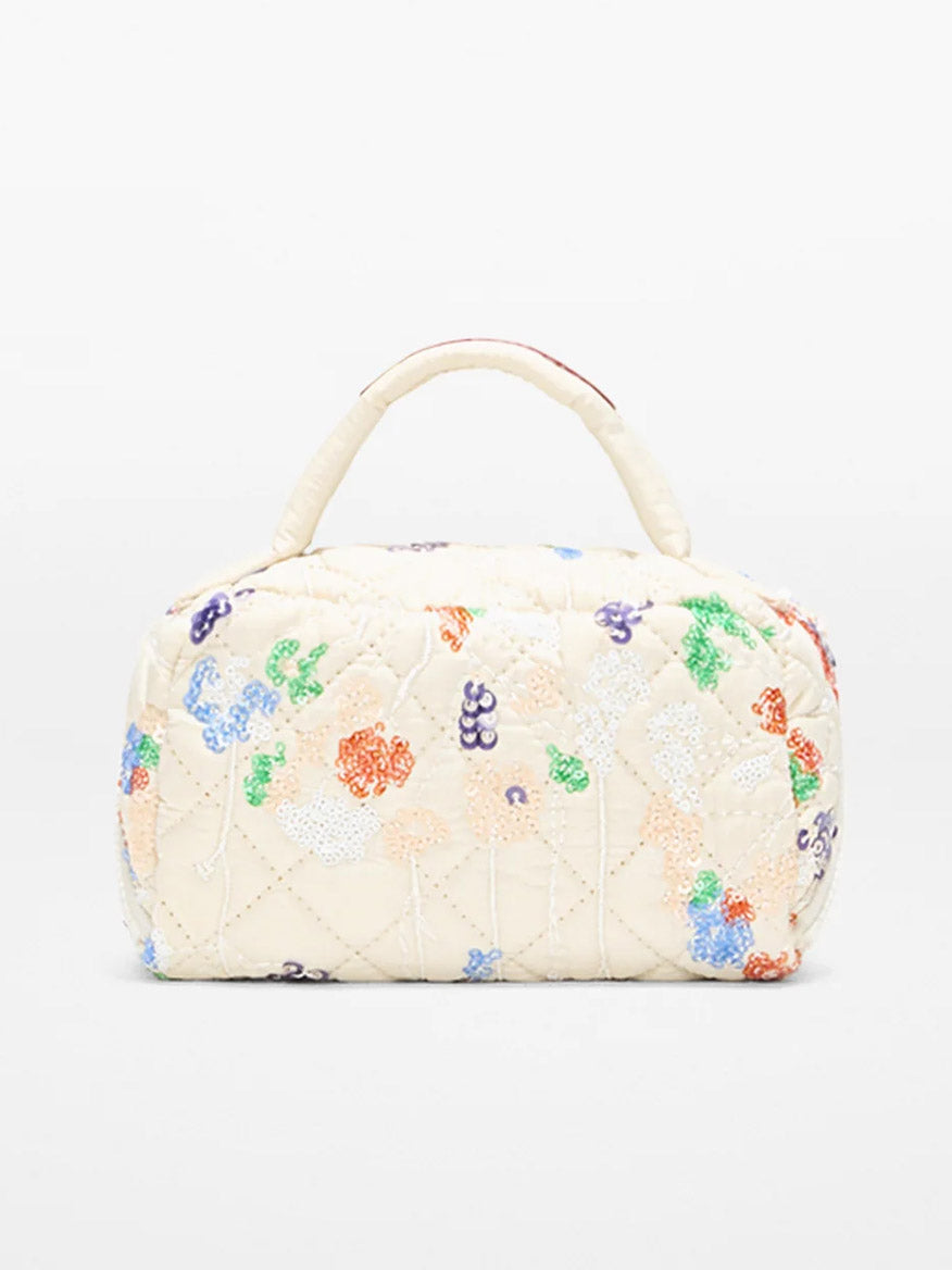 The MZ Wallace Mini Accordion Jewelry Case in Eden Sequin Oxford is a compact, cream bag with a top handle, adorned with colorful beaded floral designs and featuring interior pockets for easy organization.