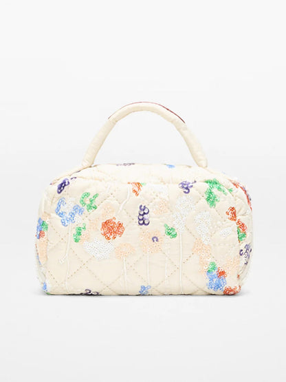 The MZ Wallace Mini Accordion Jewelry Case in Eden Sequin Oxford is a compact, cream bag with a top handle, adorned with colorful beaded floral designs and featuring interior pockets for easy organization.