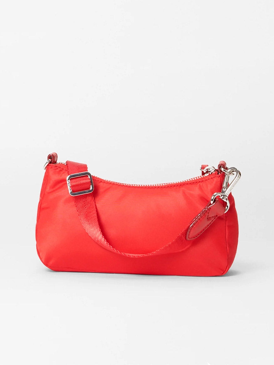 The MZ Wallace Mini Chelsea Shoulder in Bright Cherry Bedford is a compact red leather bag featuring a zippered top, adjustable strap, and metal hardware accents, all set against a plain white background.