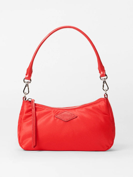 The MZ Wallace Mini Chelsea Shoulder in Bright Cherry Bedford is a small red leather handbag with a curved top handle, silver accents, a zipper closure, and an embossed logo on the front.