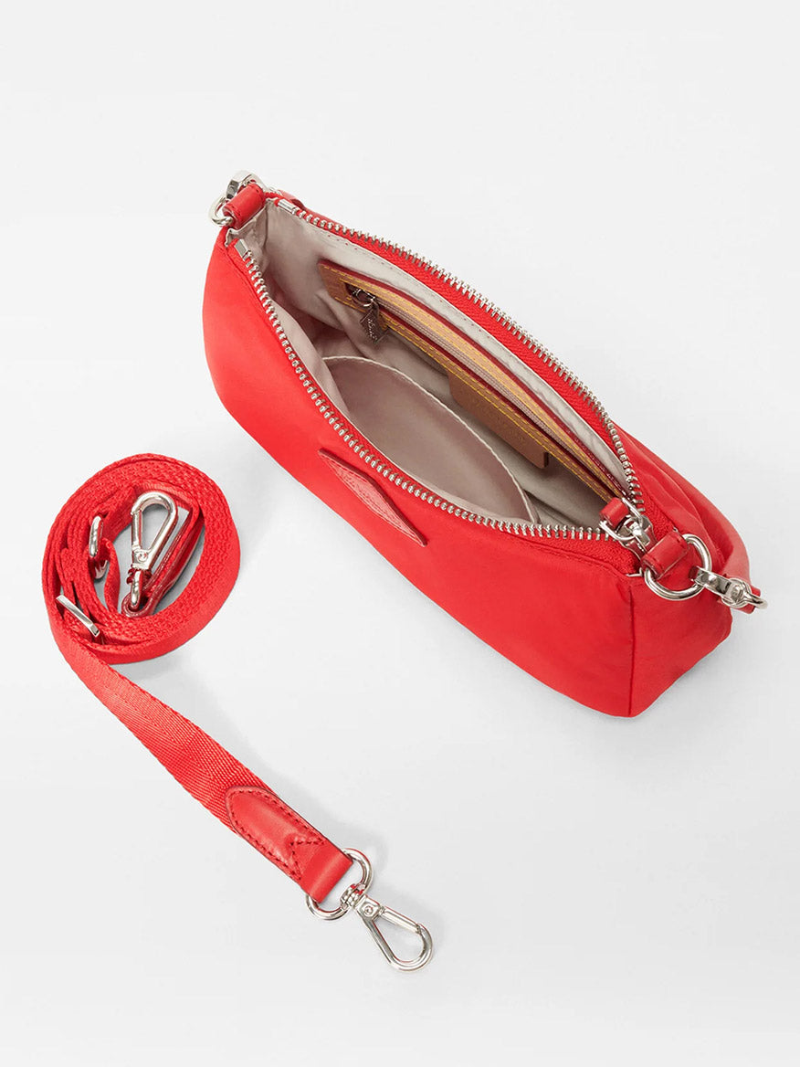 The MZ Wallace Mini Chelsea Shoulder in Bright Cherry Bedford is a chic red leather crossbody bag with a detachable strap, zippered opening, and a beige interior featuring a convenient pocket.