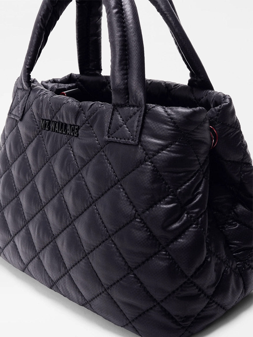 The MZ Wallace Mini City Tote in Black Oxford is a quilted black mini tote made from REC nylon, with short handles and "MZ WALLACE" stitched on the side.