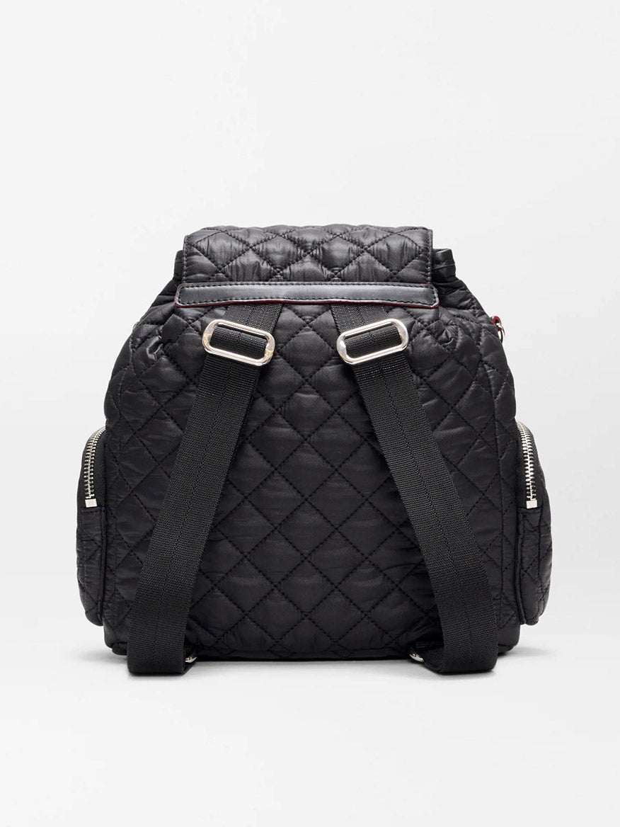 The MZ Wallace Mini Crosby Backpack in Black Oxford is shown from the back, featuring two adjustable shoulder straps and zippered side pockets. Made from recycled nylon, this stylish backpack is also eco-friendly.