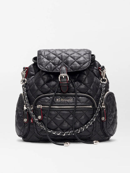 The MZ Wallace Mini Crosby Backpack in Black Oxford features recycled nylon, silver-tone hardware, zip pockets, a buckle top flap, braided chain straps, and the "MZ WALLACE" logo on the front pocket.