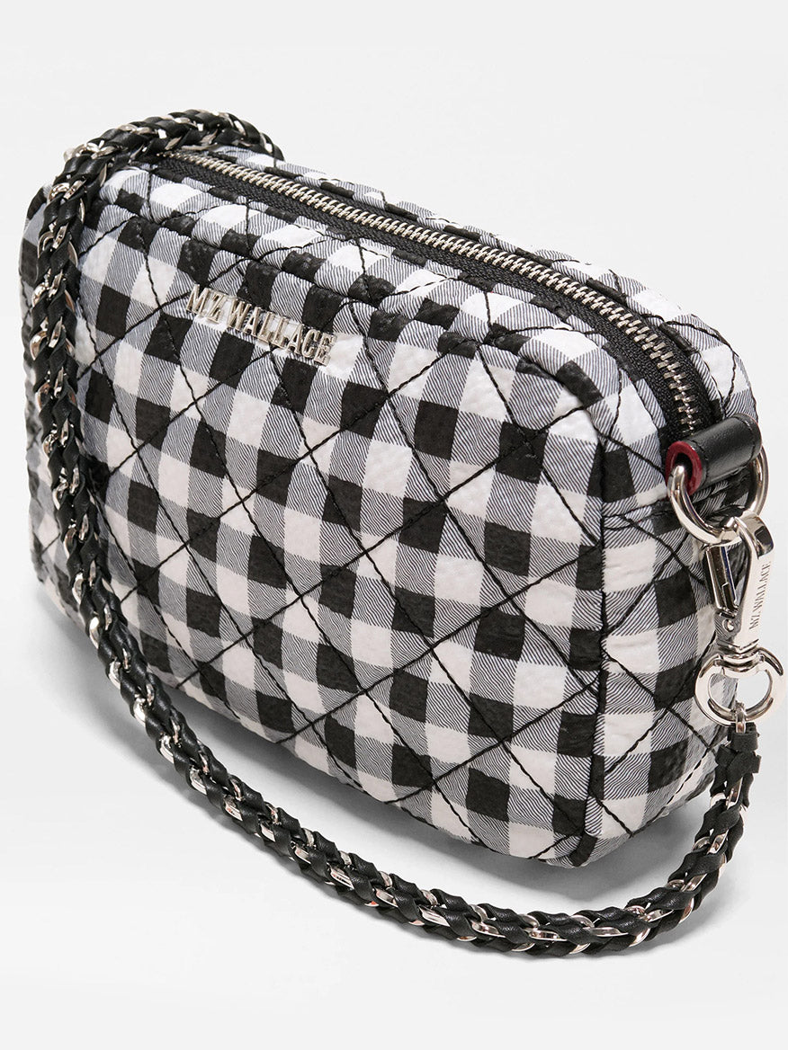 The MZ Wallace Mini Crosby Crossbody II in Black/White Gingham Oxford features quilted material, a chain and adjustable strap, zip closure, and "MZ WALLACE" on the front.