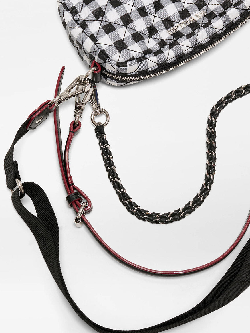 The MZ Wallace Mini Crosby Crossbody II in Black/White Gingham Oxford features a quilted finish, metal zipper, and multiple detachable straps—including an adjustable crossbody strap and a black woven chain.