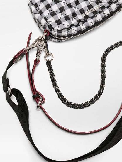 The MZ Wallace Mini Crosby Crossbody II in Black/White Gingham Oxford features a quilted finish, metal zipper, and multiple detachable straps—including an adjustable crossbody strap and a black woven chain.