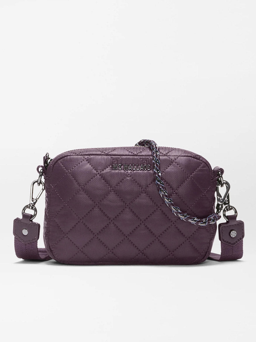 The MZ Wallace Mini Crosby Crossbody II in Raisin Oxford is a small, quilted purple bag made from recycled Oxford nylon, featuring detachable straps, silver hardware, and a braided detail on the zipper pull, shown against a plain white background.