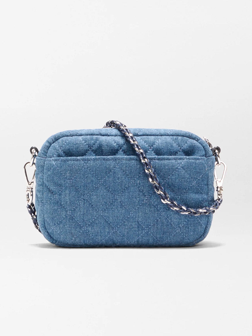 The MZ Wallace Mini Crosby Crossbody II in True Blue Denim is a small rectangular bag with quilted details, silver hardware, and a detachable chain strap, shown against a plain white background.