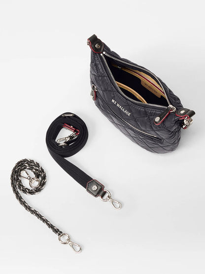 The MZ Wallace Mini Crosby Sienna in Black Oxford features silver hardware and comes with two detachable straps—one black and one braided adjustable—shown against a white background.