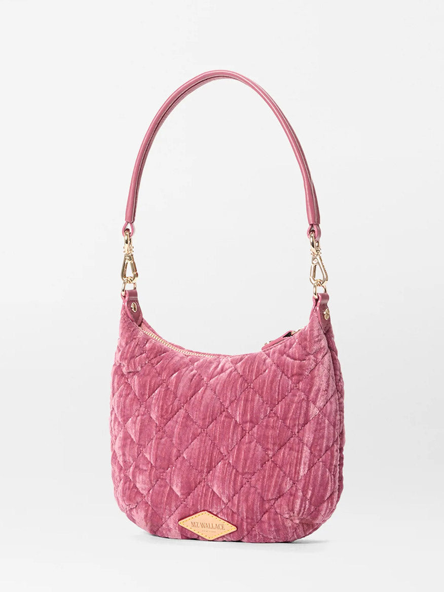 The MZ Wallace Mini Crosby Sienna in Petal Velvet is a pink quilted satchel with a curved handle, gold hardware, and a small gold nameplate on the front—ideal as your everyday shoulder bag.