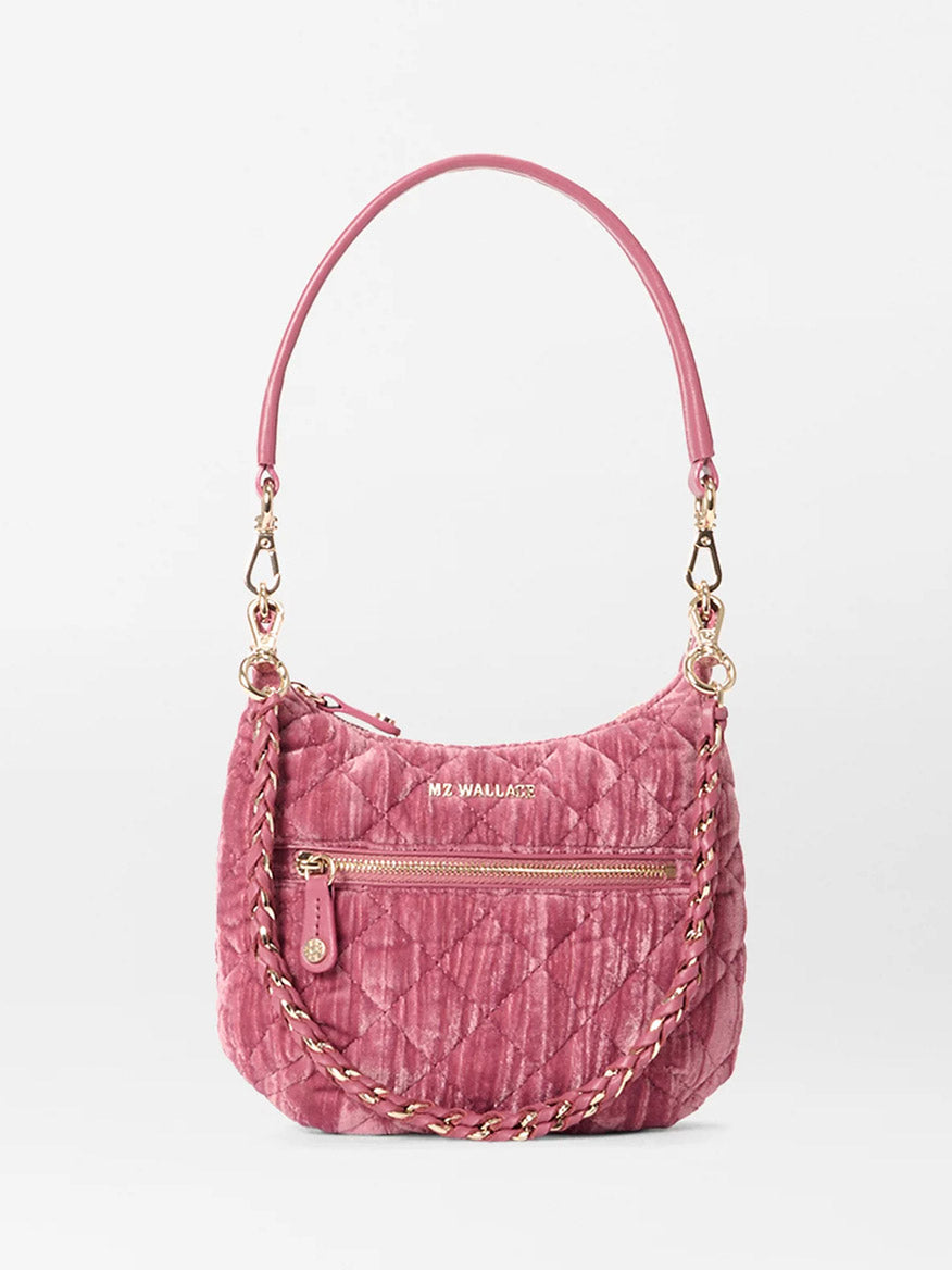 The MZ Wallace Mini Crosby Sienna in Petal Velvet is a small quilted pink satchel with gold hardware, a zippered front pocket, Italian leather handles, a braided chain strap, and the "MZ WALLACE" logo—ideal for everyday use.