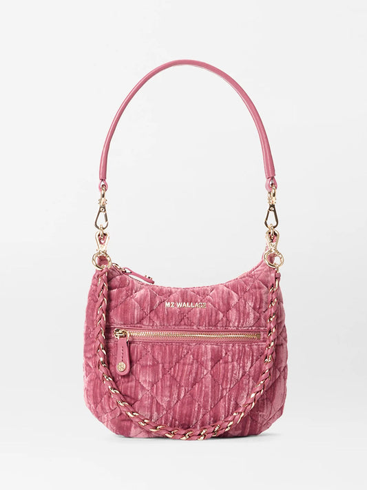 The MZ Wallace Mini Crosby Sienna in Petal Velvet is a small quilted pink satchel with gold hardware, a zippered front pocket, Italian leather handles, a braided chain strap, and the "MZ WALLACE" logo—ideal for everyday use.