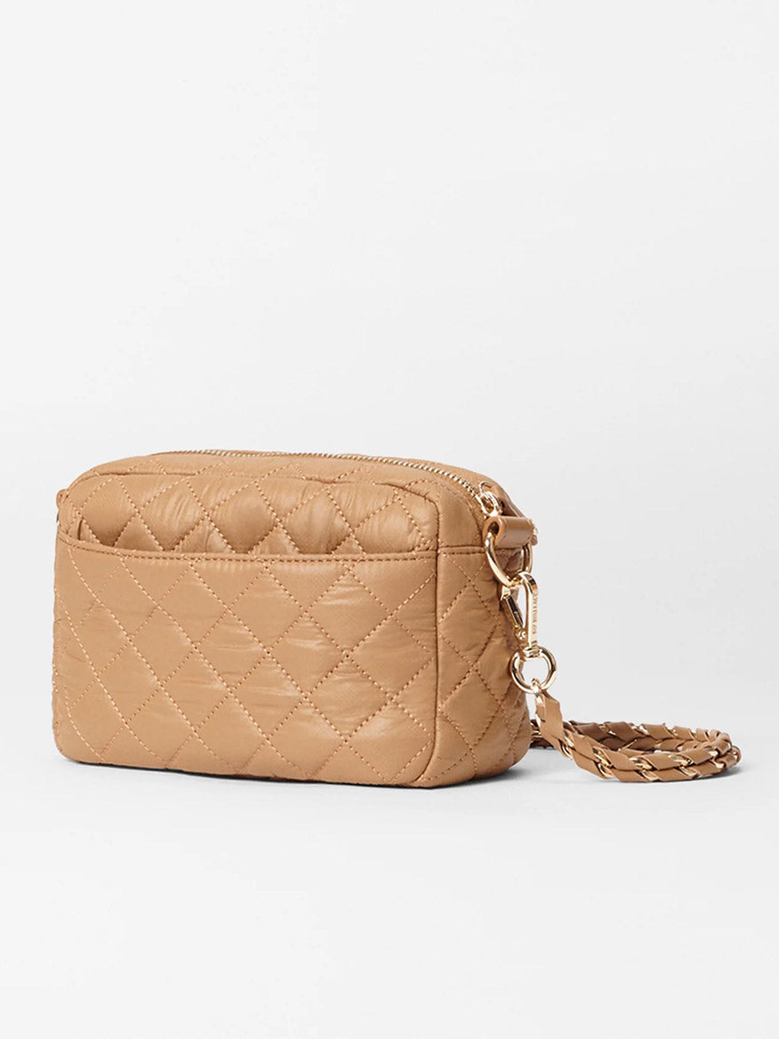 The MZ Wallace Mini Crosby in Caramel Oxford is a tan quilted shoulder bag made from Italian leather, featuring a gold chain crossbody strap and zipper closure, all set against a plain white background.