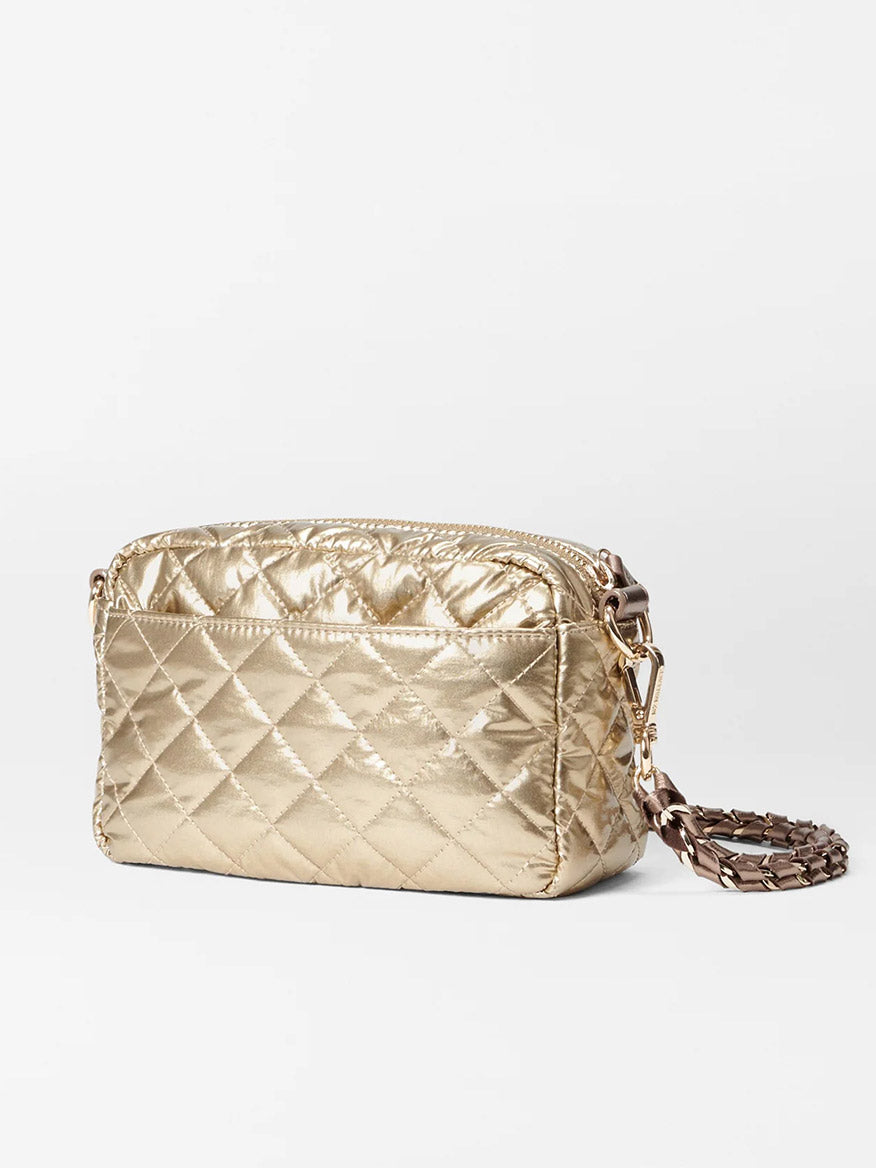 The MZ Wallace Mini Crosby in Antique Gold Metallic Oxford is crafted from luxurious Italian leather, featuring a zipper closure and chain crossbody strap. Set against a pristine white background, this exquisite shoulder bag epitomizes elegance and functionality, making it perfect for any stylish occasion.