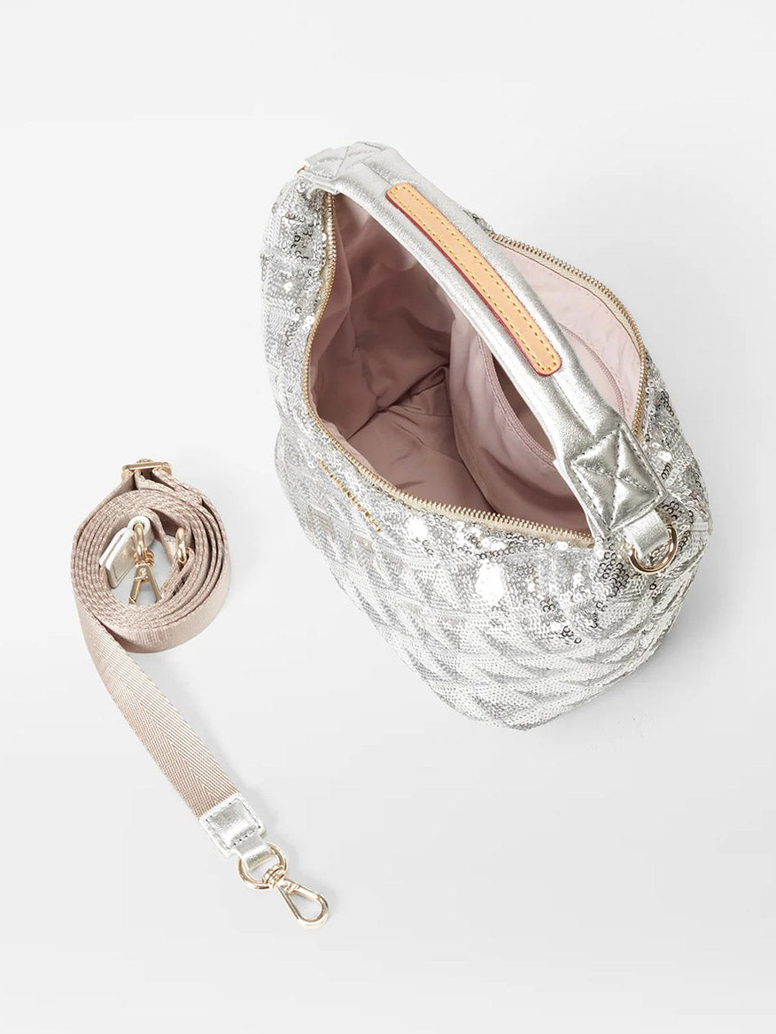 The MZ Wallace Mini Hobo in Ice Multi Sequin Oxford is shown with an open view of its light pink interior, featuring a detachable beige strap with metal clasps, set against a white background.