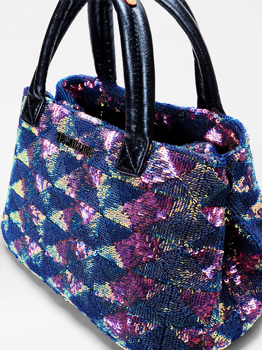 The MZ Wallace Mini Metro City Tote in Aurora Sequin features black handles and a blue and pink geometric sequin design—perfect as a mini tote for adding sparkle to any outfit.