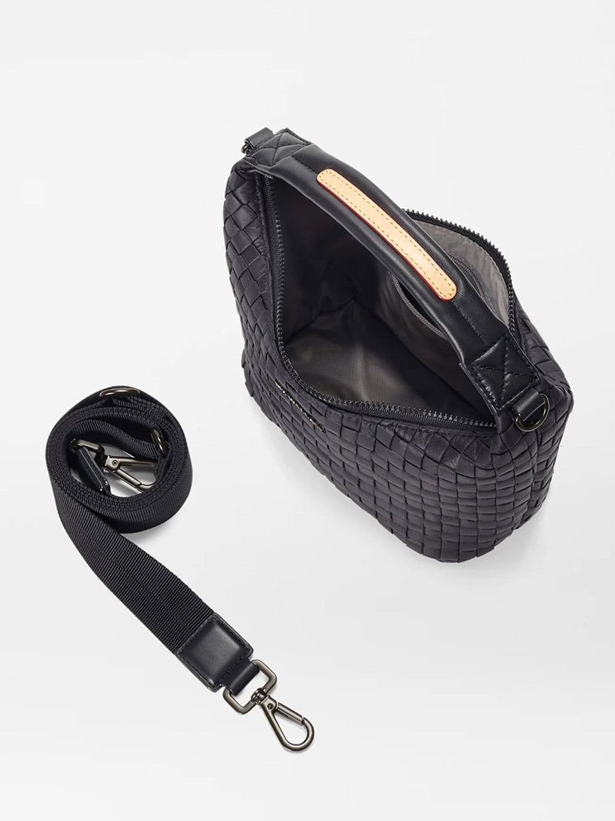 The MZ Wallace Mini Woven Hobo in Black Oxford features a black woven design with an open top that reveals a gray interior, accompanied by an adjustable crossbody strap with metal clasps, epitomizing the brand's craftsmanship.