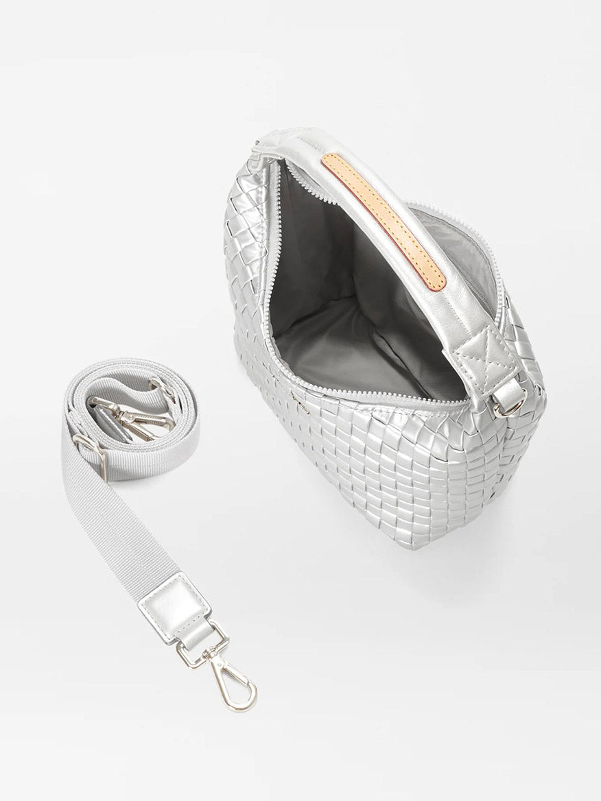 The MZ Wallace Mini Woven Hobo in Matte Silver Oxford features a top handle, an open zipper that reveals the inside lining, a detachable adjustable nylon crossbody strap, and natural Italian leather trim.