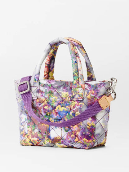 A MZ Wallace Petite Metro Tote Deluxe in Cherry Blossom Oxford with two padded nylon handles, a zipper, and an adjustable crossbody strap, set against a plain background.