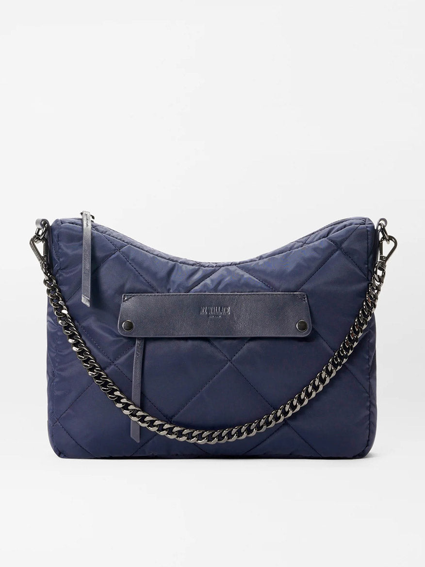 Introducing the MZ Wallace Quilted Madison Uptown Crossbody in Dawn: a navy blue handbag with a chain strap and Italian leather detailing, featuring a small, embossed logo.