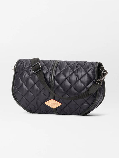 The MZ Wallace Small Astor Convertible Clutch in Black Oxford is a black quilted crossbody bag with Italian leather, a front zipper, adjustable strap, and a tan "MZ Wallace" patch label.
