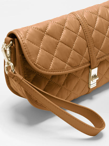 MZ Wallace Small Astor Convertible Clutch in Cognac Oxford, a tan quilted recycled nylon bag featuring a wrist strap and a silver metal turn-lock closure.