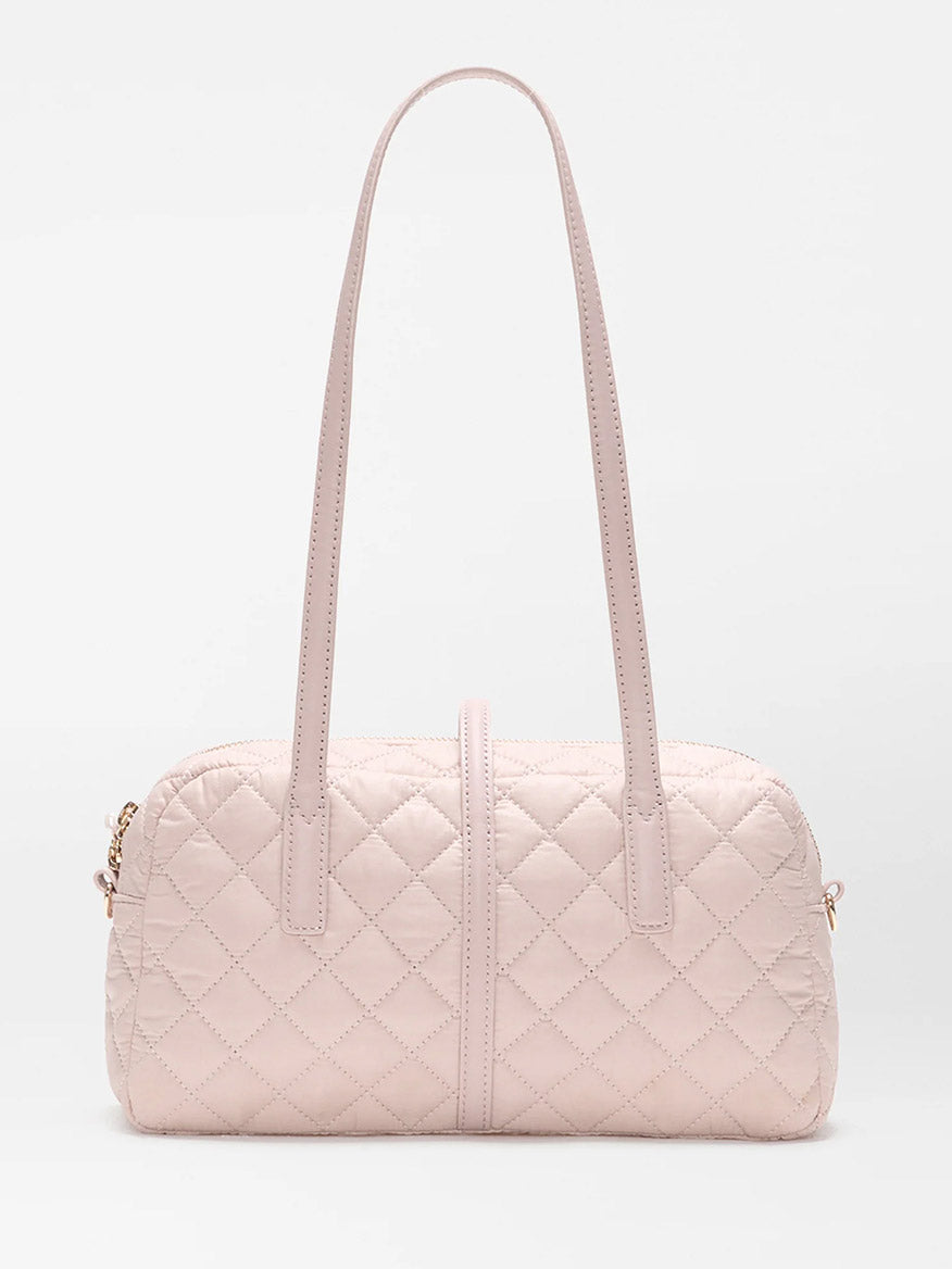 The MZ Wallace Small Astor Satchel in City Pink Oxford, a light pink quilted nylon bag with Italian leather trim, double shoulder straps, and gold-tone hardware, is displayed against a plain white background.