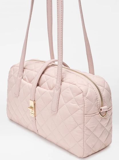 The MZ Wallace Small Astor Satchel in City Pink Oxford features light pink quilted nylon, Italian leather trim, dual shoulder straps, a gold-tone clasp, and a zipper closure, displayed against a plain white background.